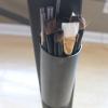 A close look at the pencil holder on the artist desk. 